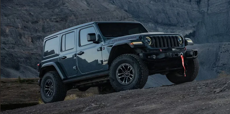 A dark blue 2026 Jeep Wrangler off-roading.