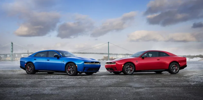 A red and blue 2026 Dodge Charger facing each other with a bridge in the backround.
