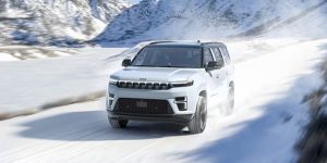 New 2026 Jeep Grand Wagoneer cruising in snow